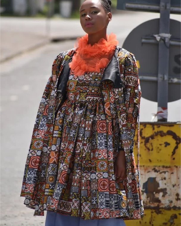 Printed swing coat worn over wide trousers