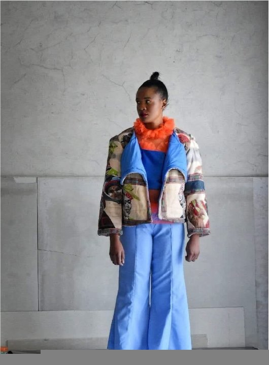 Printed jacket with blue panels over wide trousers